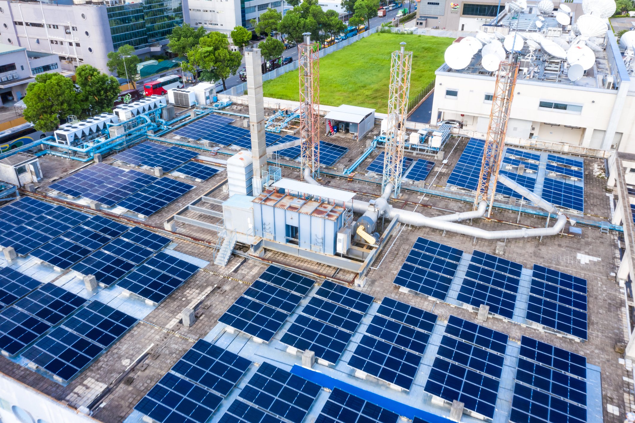 An areal shot of a warehouse rooftop utilizing solar panels for power