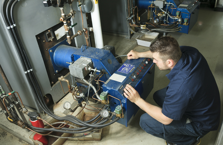 An industrial electrician repairing fixture 