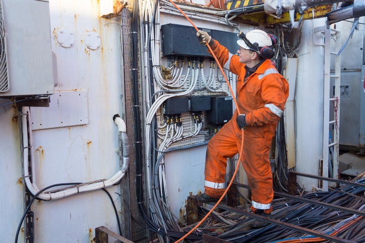 An electrician works on an oil rig